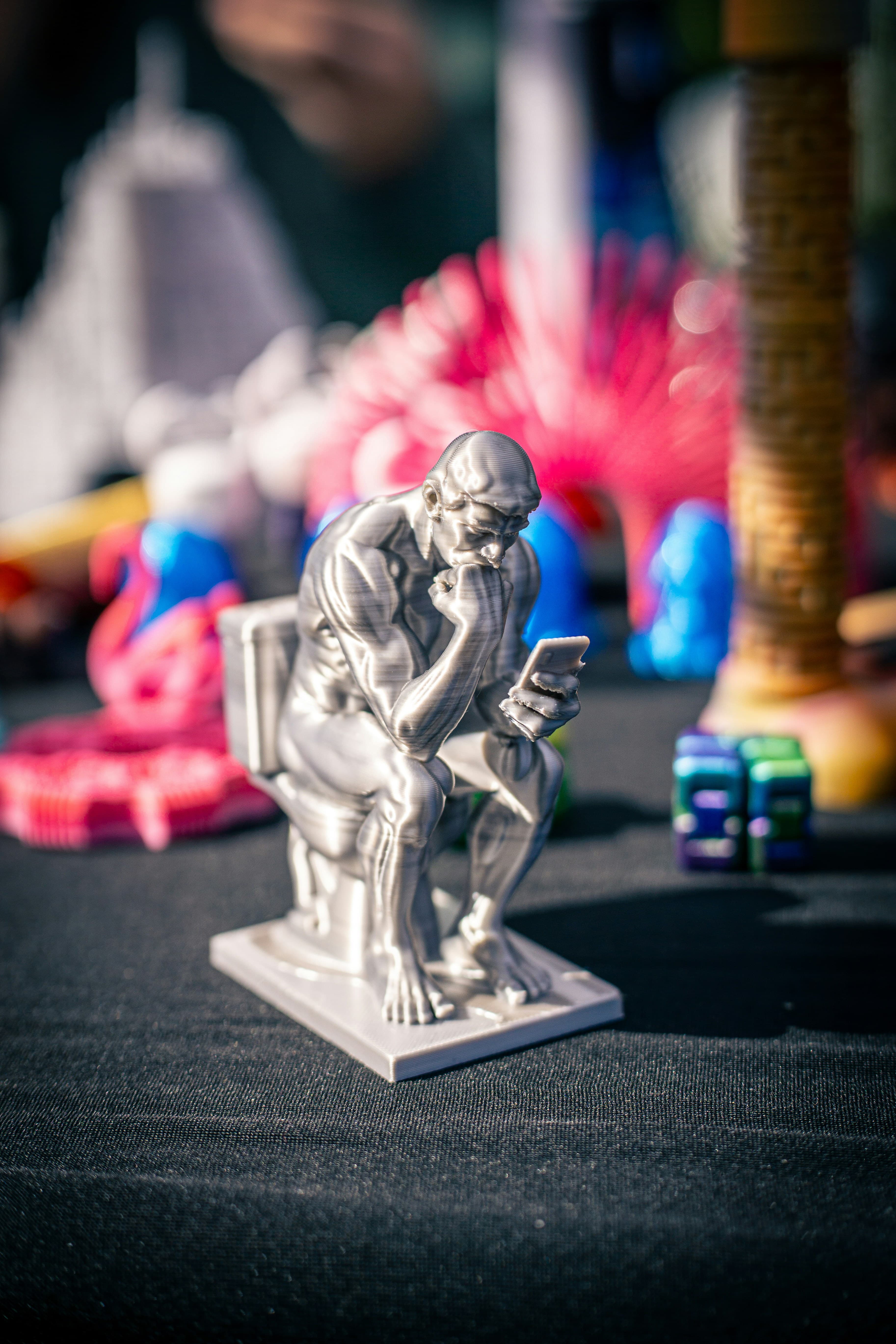 Thinker statue with phone