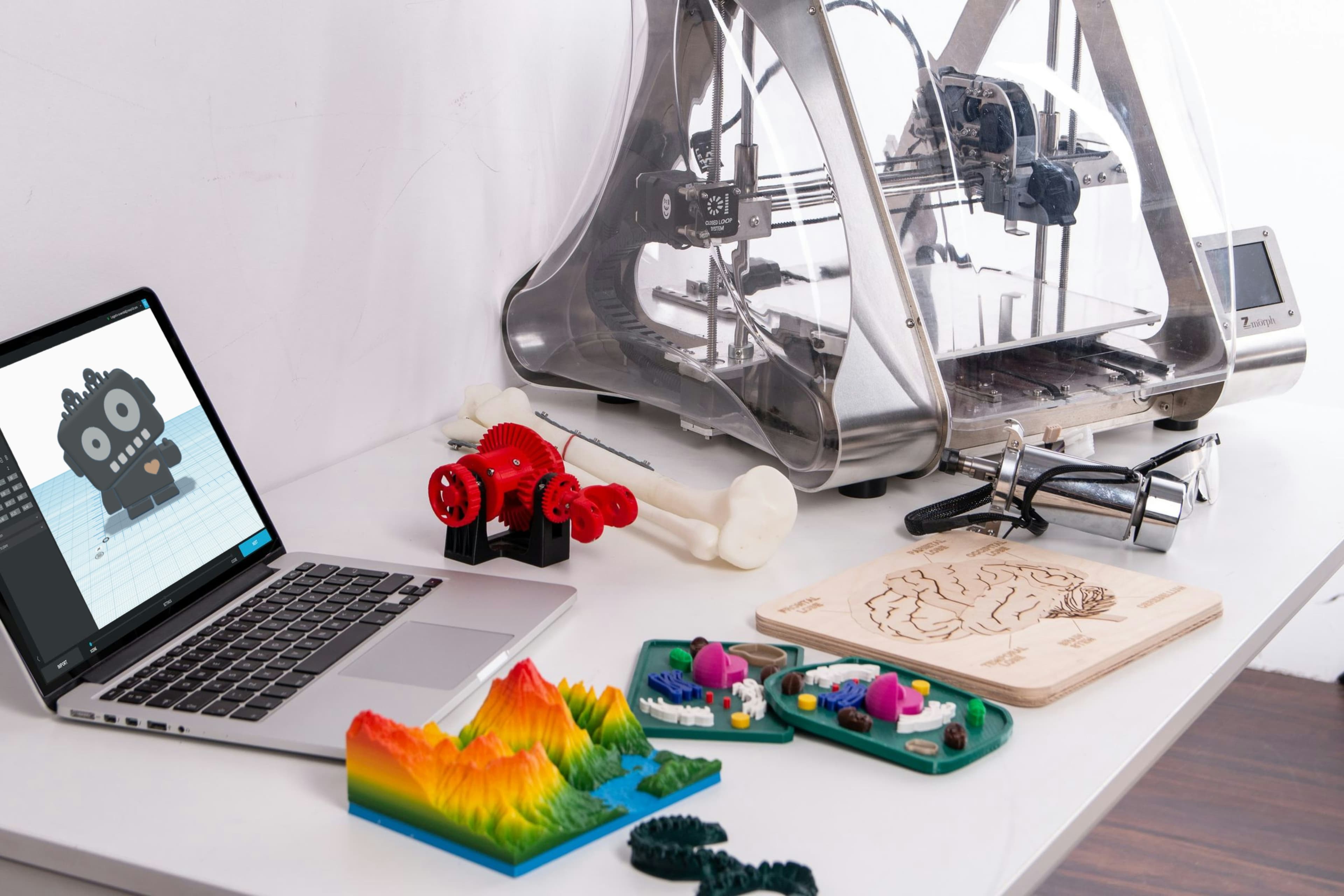 Laptop beside compact 3D printer