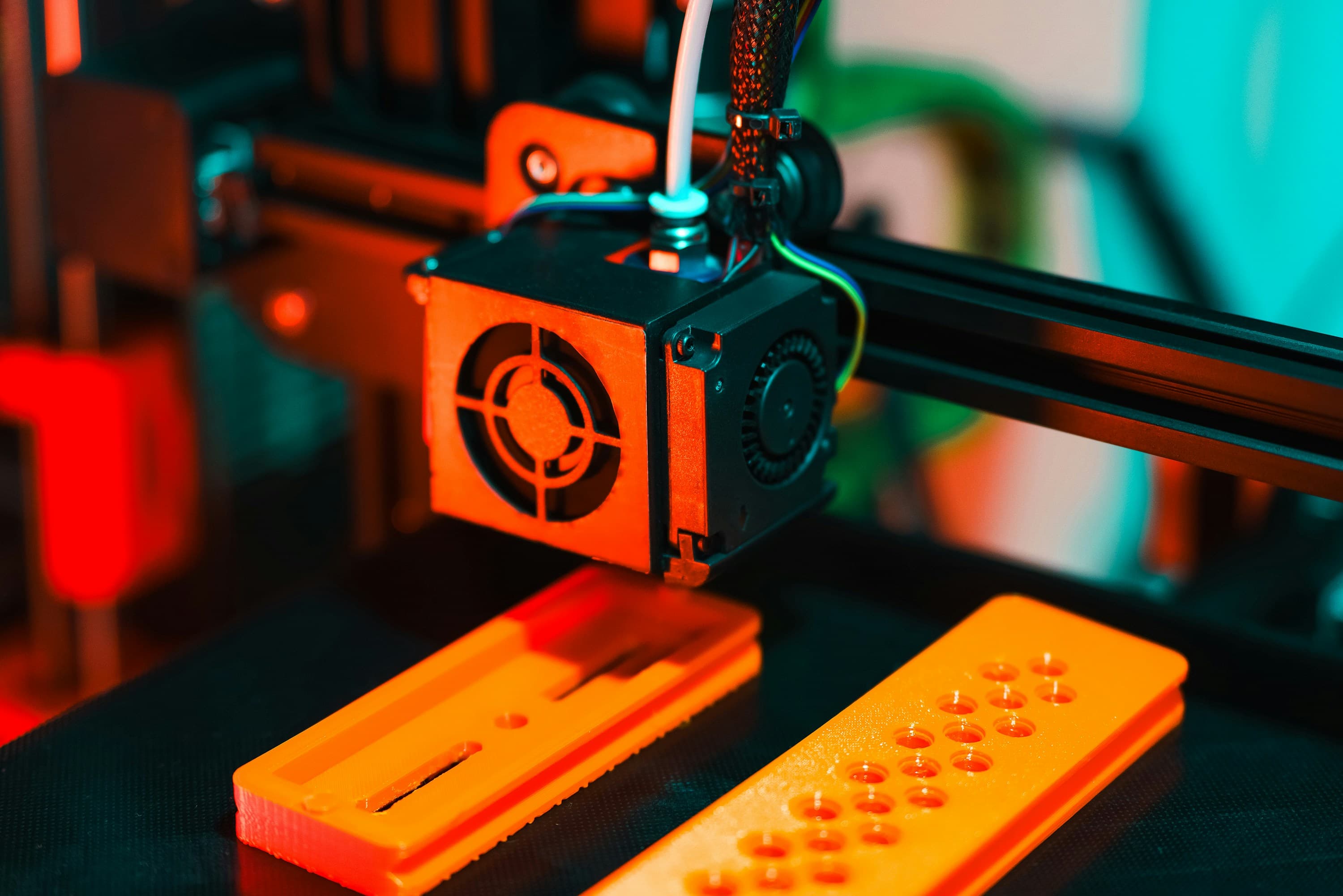 3D printer manufacturing orange prototype